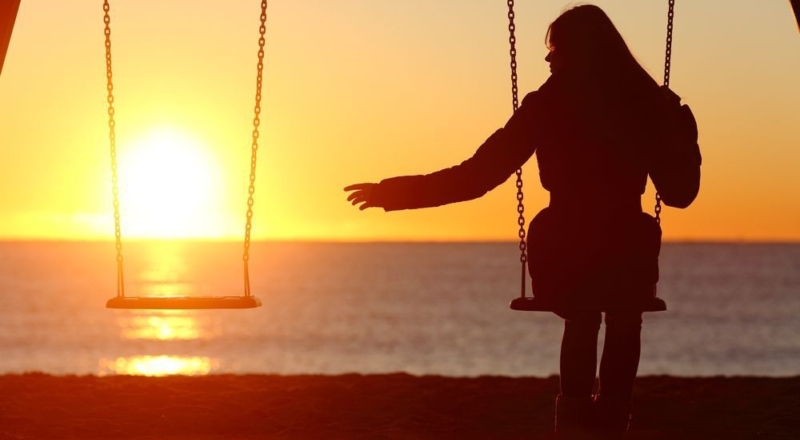 A girl sits on a swing by herself grieving a loss. She has decided to start grief counseling in Forest Hills, NY with grief counselor Deborah Karnbad.